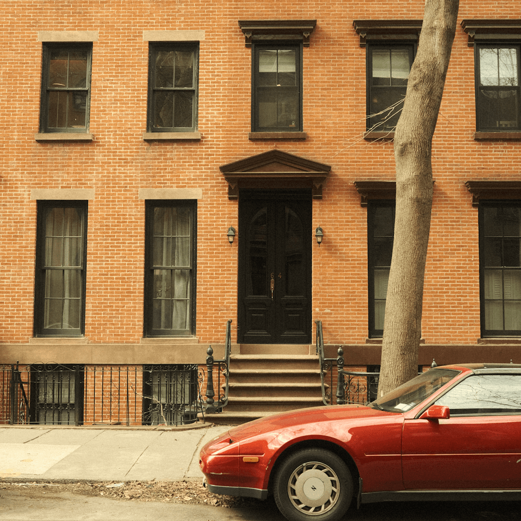 The scene is set outdoors in front of a classic urban townhouse.