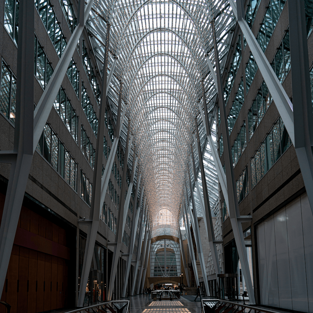 The scene depicts an expansive indoor atrium with a striking architectural design.