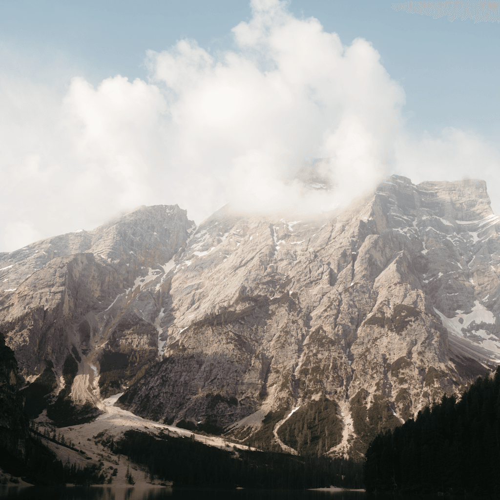 The scene is set outdoors in a mountainous landscape during what appears to be late afternoon, given the soft light that bathes the area.