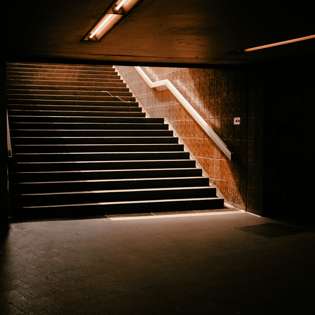 The scene unfolds within an indoor setting, likely a subway or underground passage.